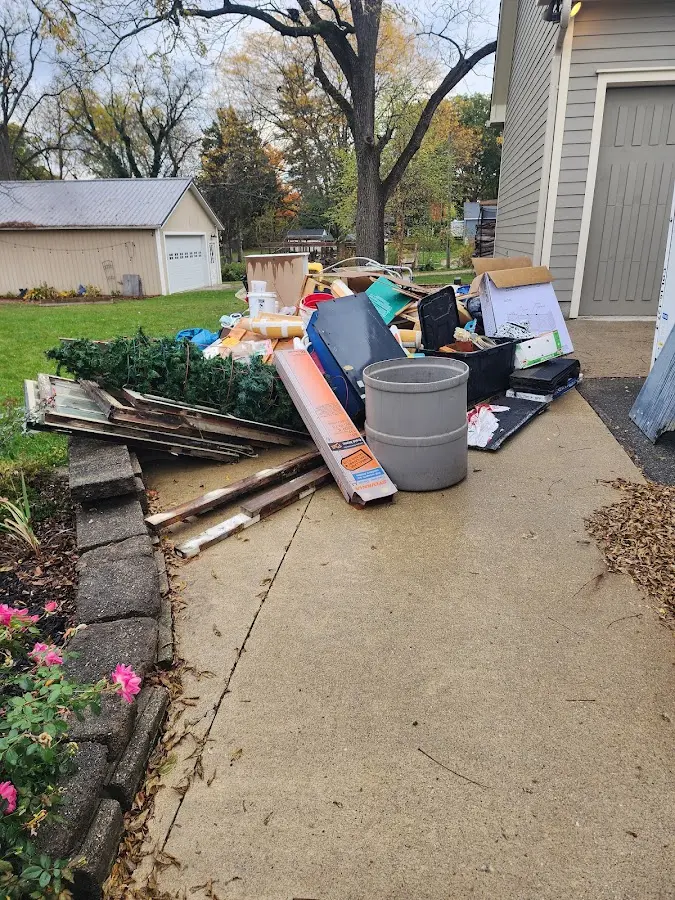 Dumpster being loaded with debris for Demolition Dumpster Rental in Charles City
